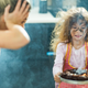 Girl with soot-covered face holds burnt cake